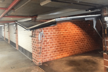 Garage door panel with a visible dent from damage
